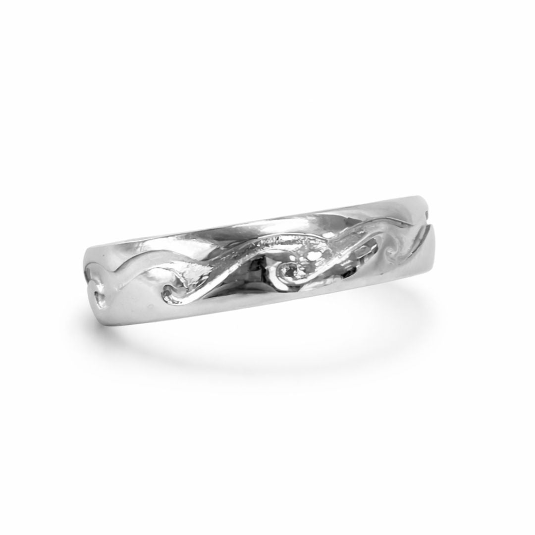 Silver ring with intricate design on a white background