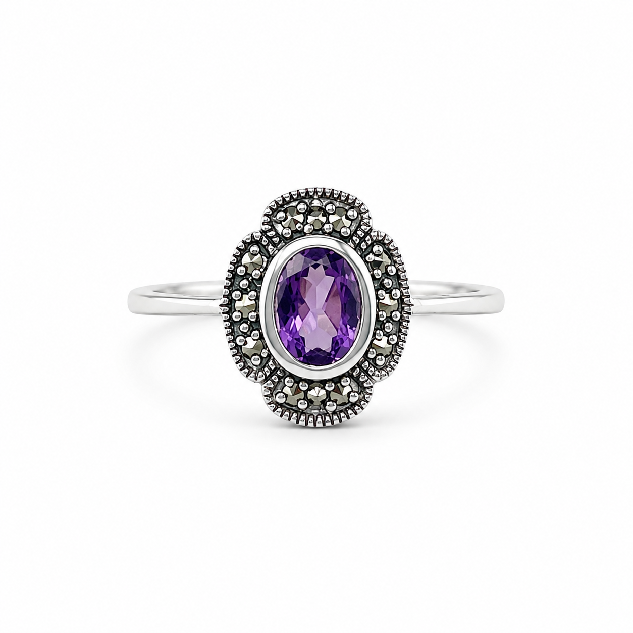 Silver ring with a purple gemstone on a white background