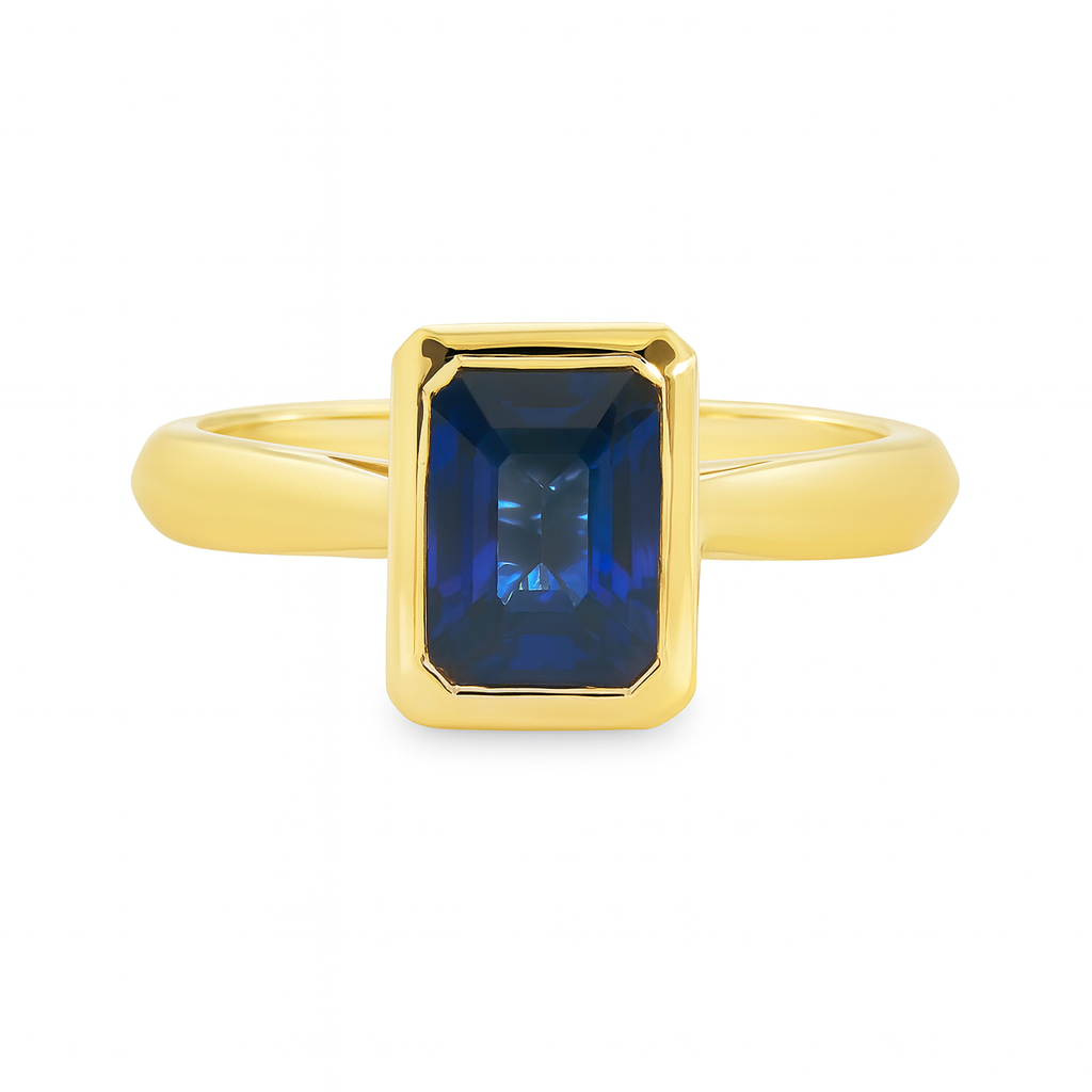Lennon 18ct Yellow Gold Ring with Bezel-Set Emerald Cut Ceylon Sapphire – 1.29ct
