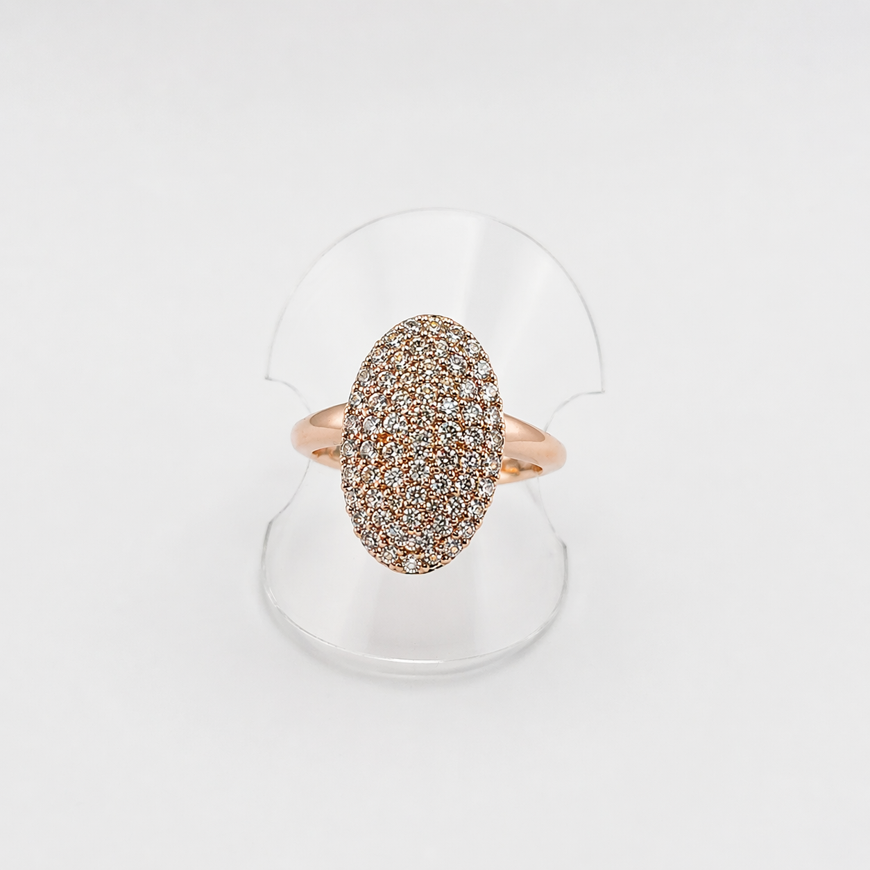 Rose gold ring with diamond-like stones on a white background