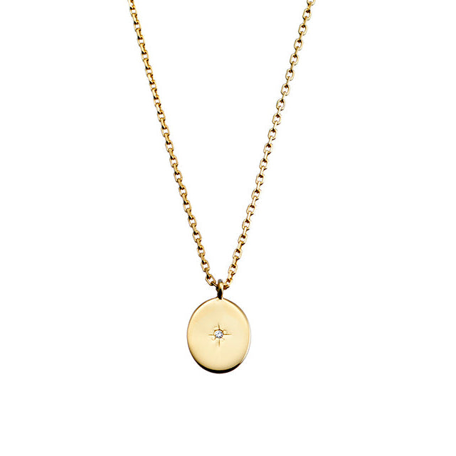 Gold necklace with a round pendant on a white background