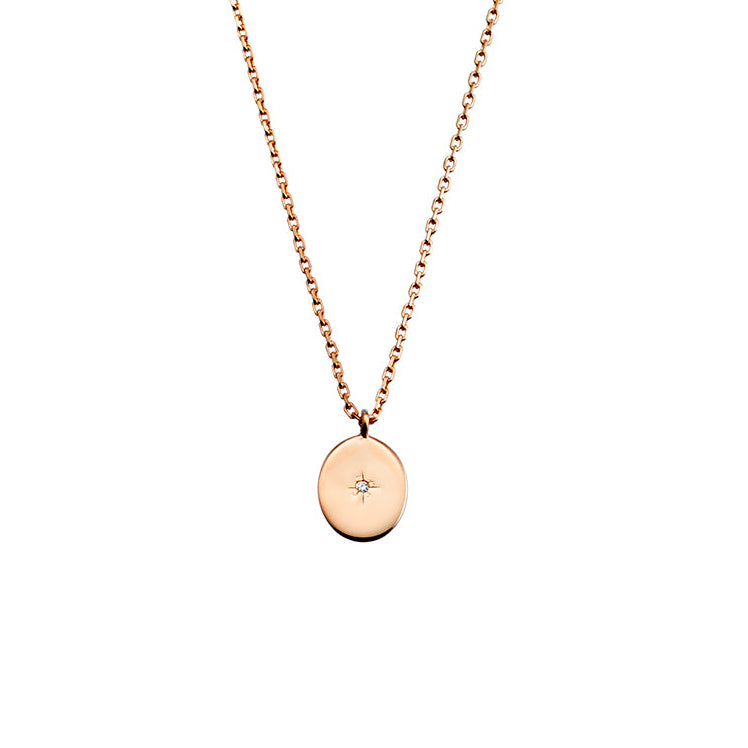 Rose gold necklace with a round pendant on a white background