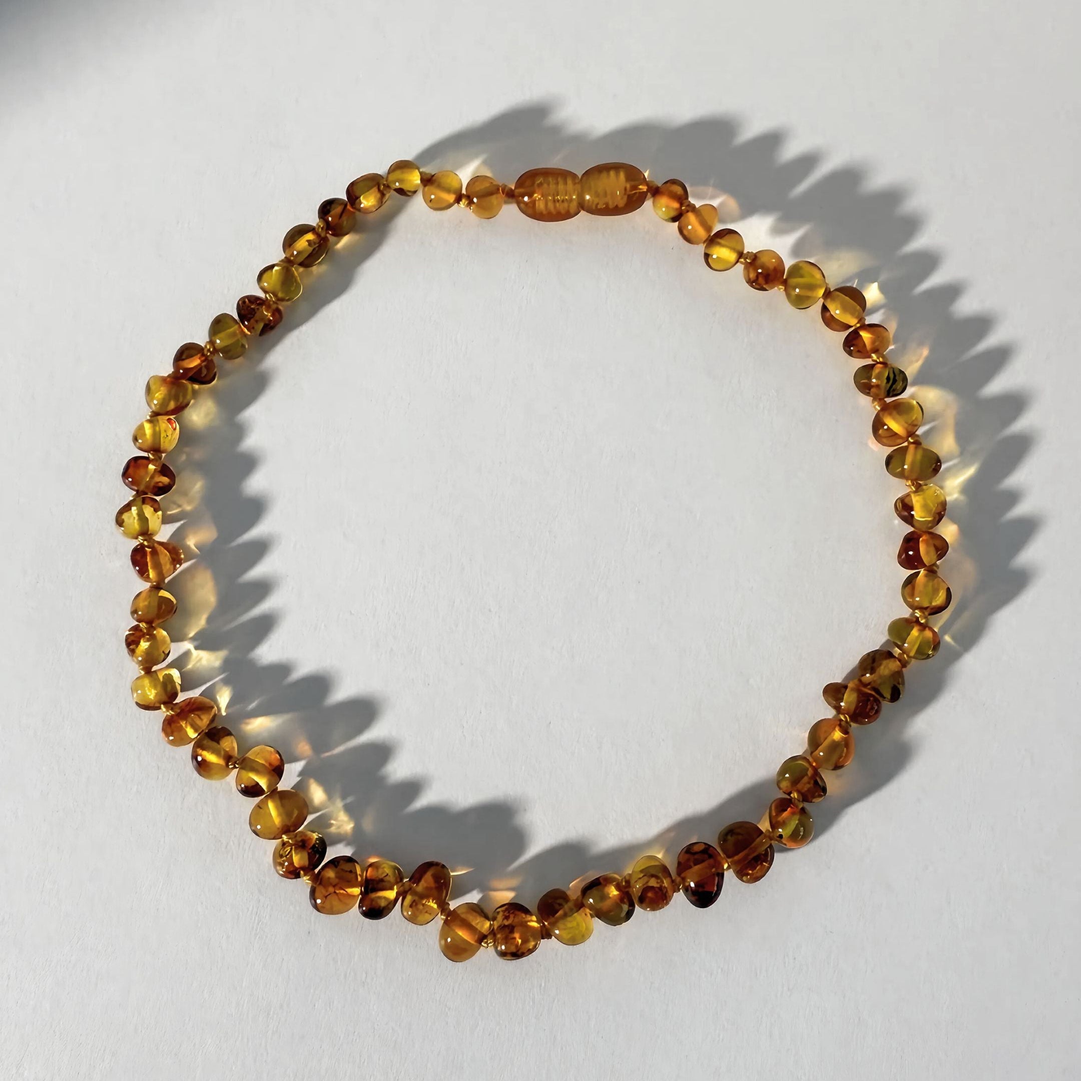 Amber beaded bracelet on a white background