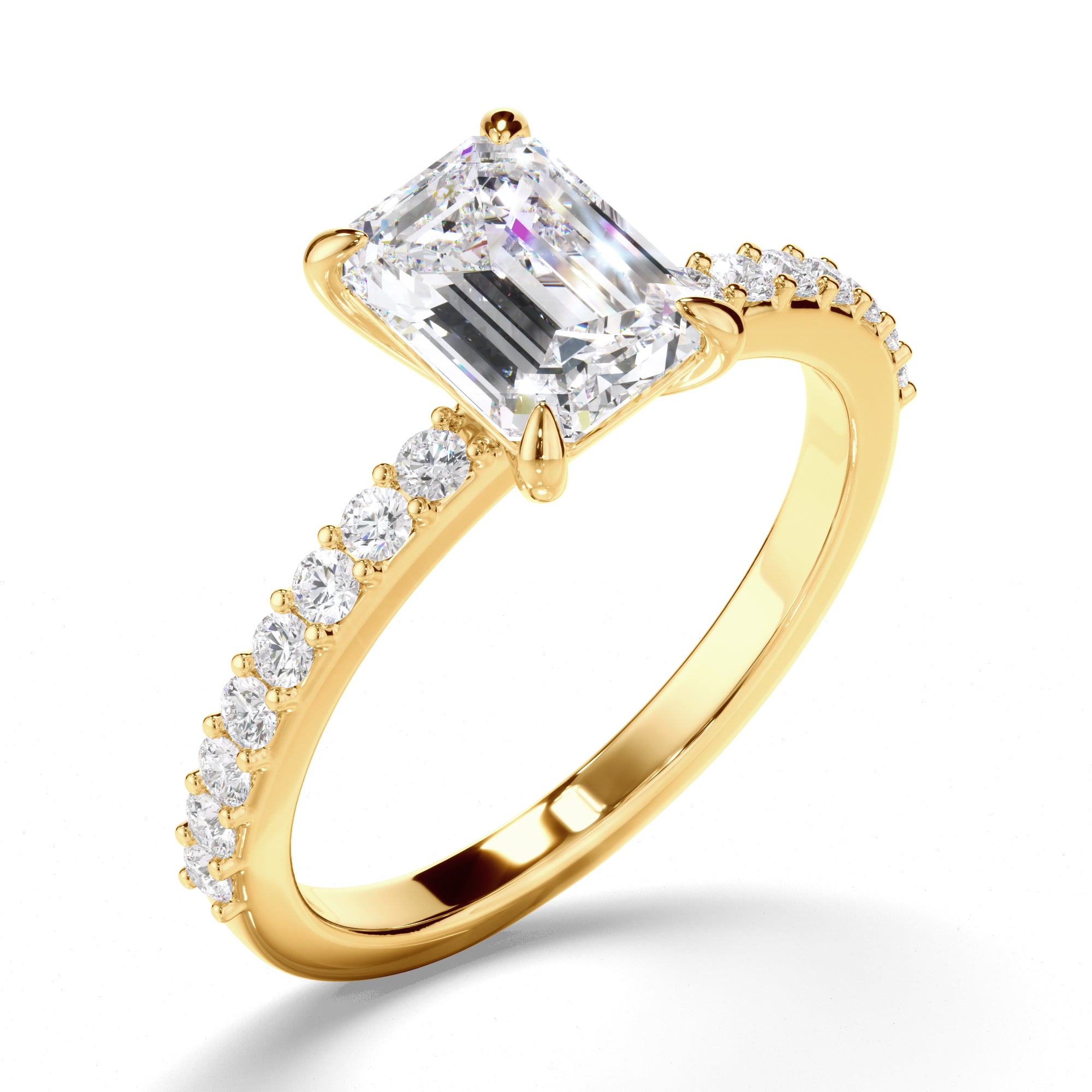 Yellow gold ring with a large emerald diamond and smaller diamonds on the band against a white background