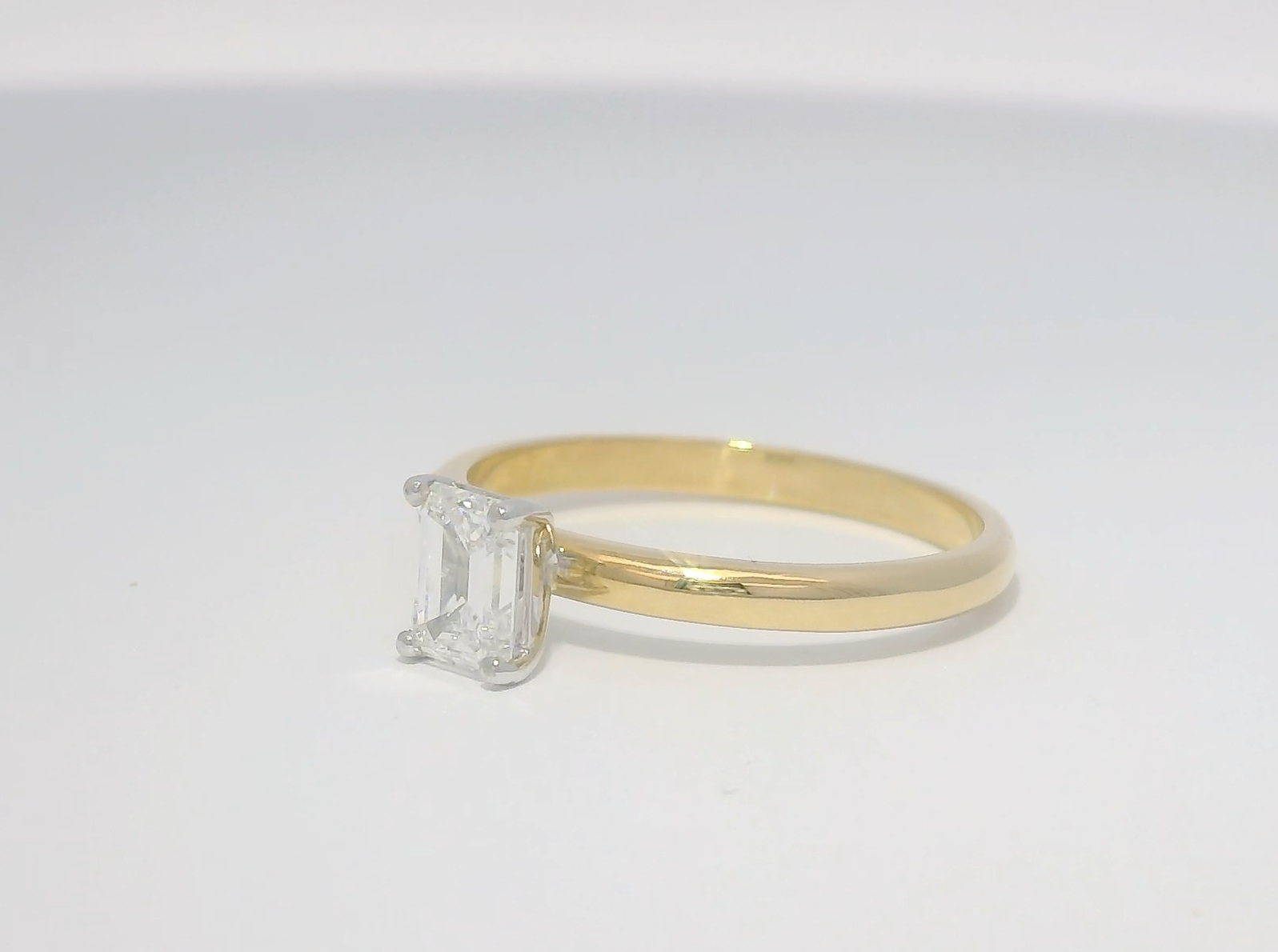 Emerald cut diamond gold solitaire engagement ring