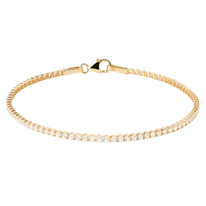 Gold bracelet with a clear stone on a light gray background