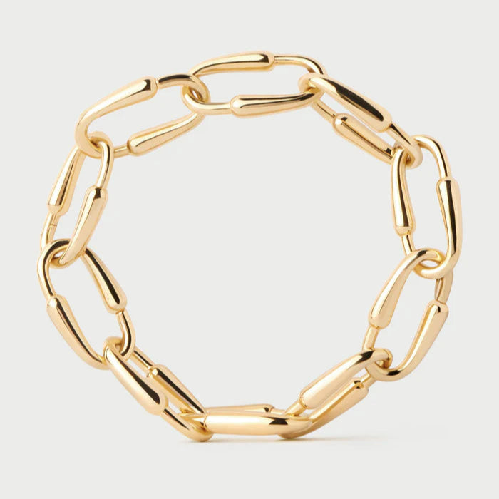 Gold chain bracelet on a light gray background