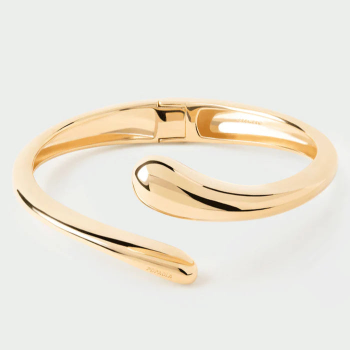 Gold bracelet on a light gray background