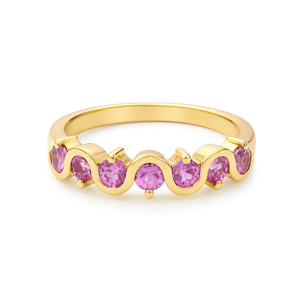 Gold ring with pink gemstones on a white background