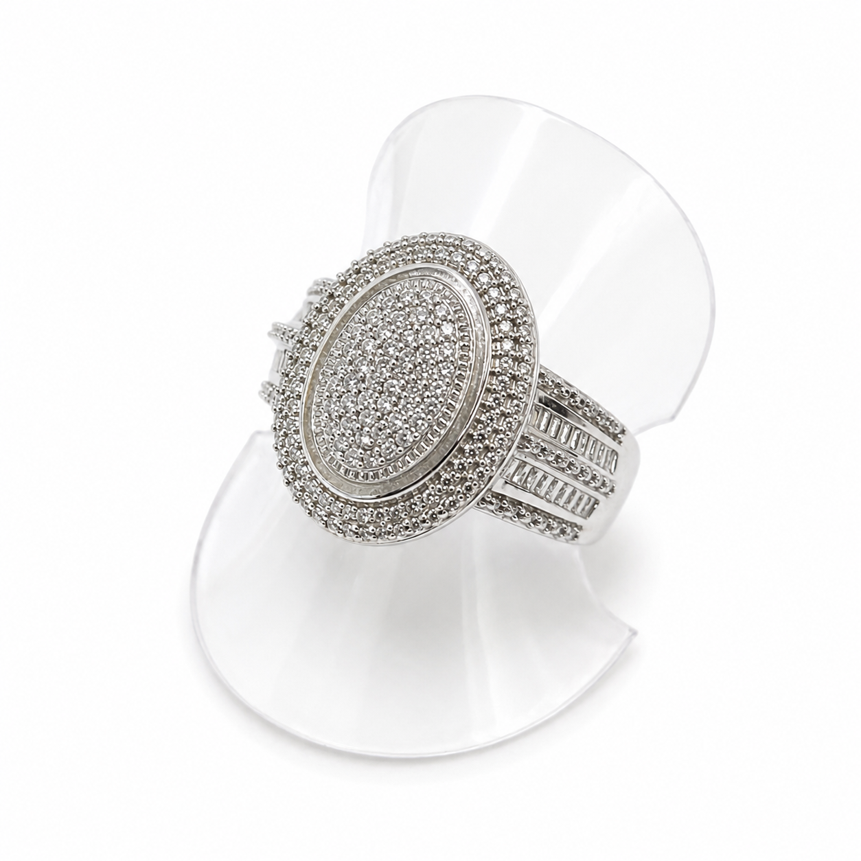 Silver ring with gemstones on a white stand