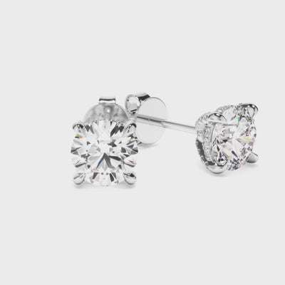 white gold round diamond earrings rotating in a video
