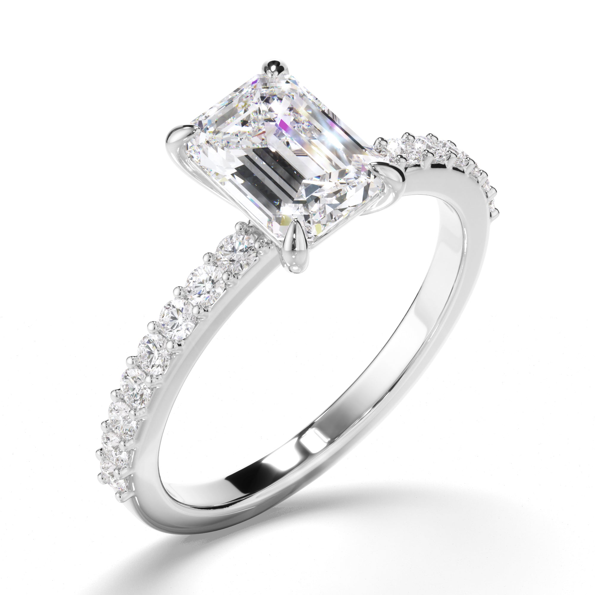 Diamond ring with a large central emerald and smaller diamonds on the band against a white background