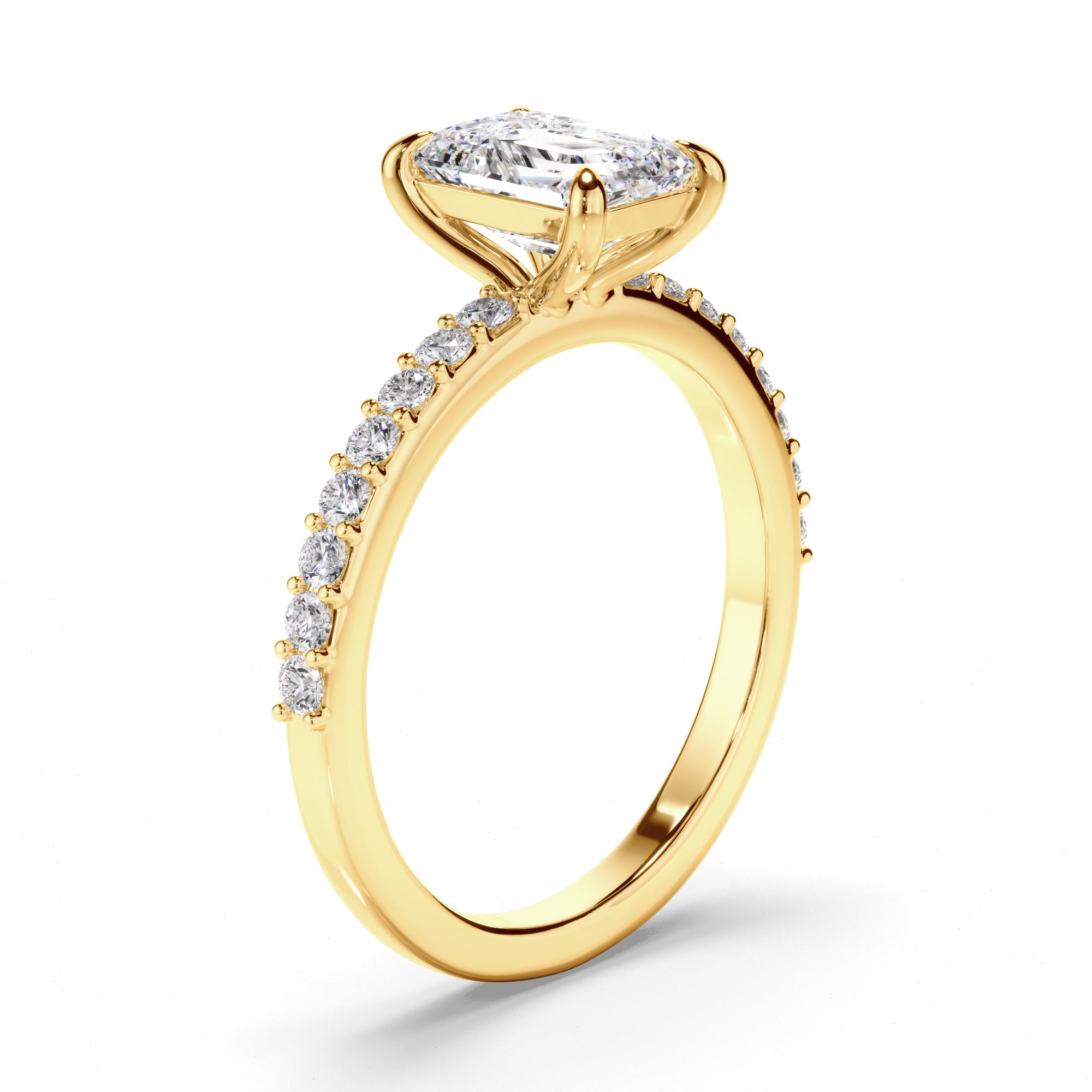 Yellow gold ring with emerald diamond and diamond accents on a white background